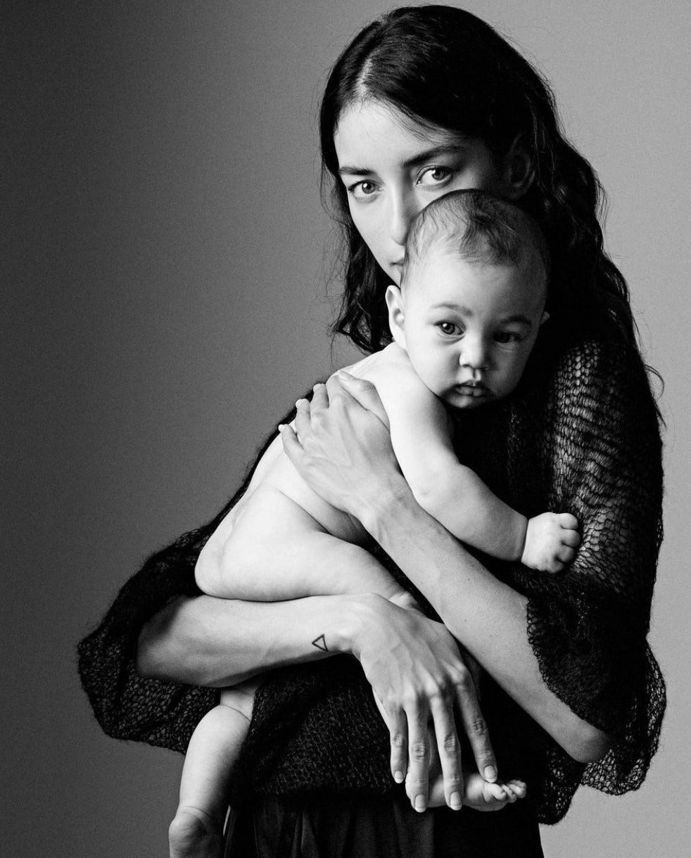 Image of a new mother holding her baby close 