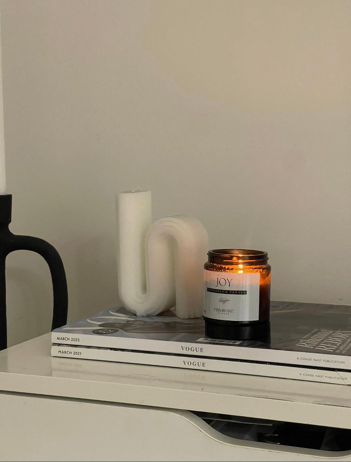 Luxury botanical candle styled in calming neutral home interior