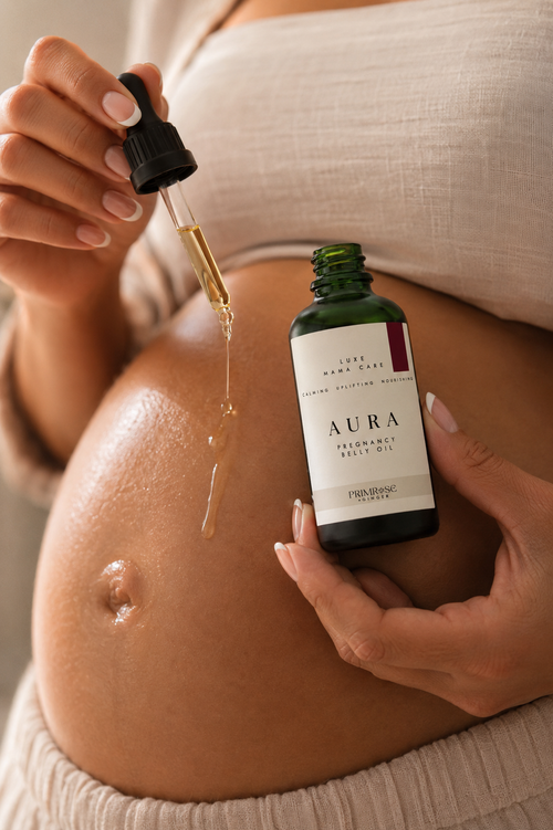 Pregnant woman applying nourishing belly oil for stretch mark support