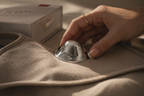 Reusable silver nursing cups placed inside soft nursing bra for discreet comfort